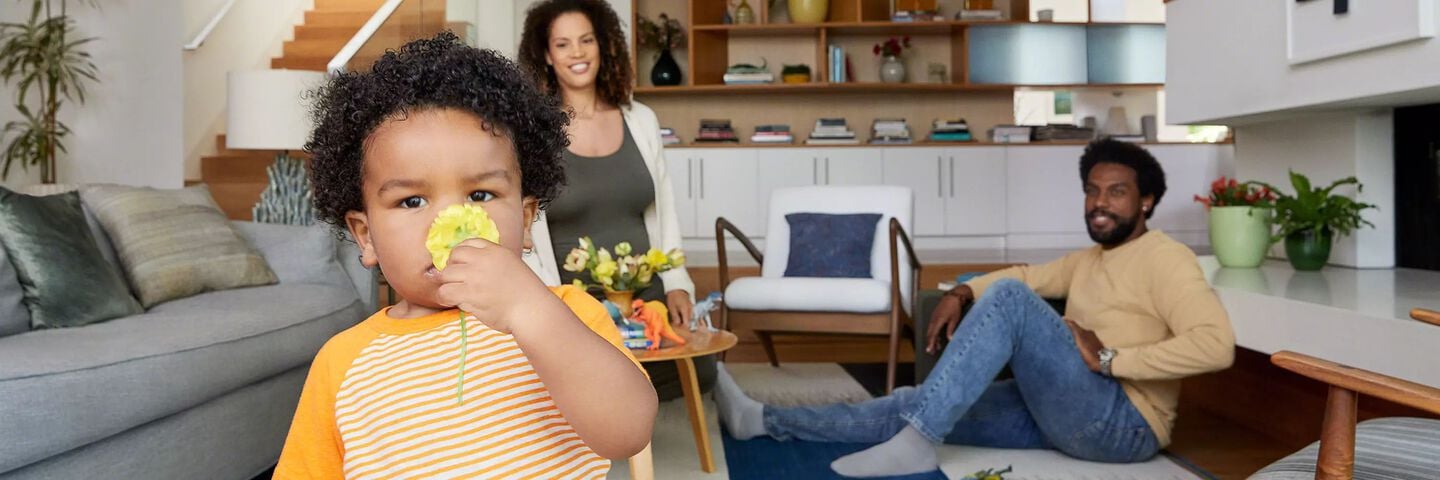 Child with flower sitting with family