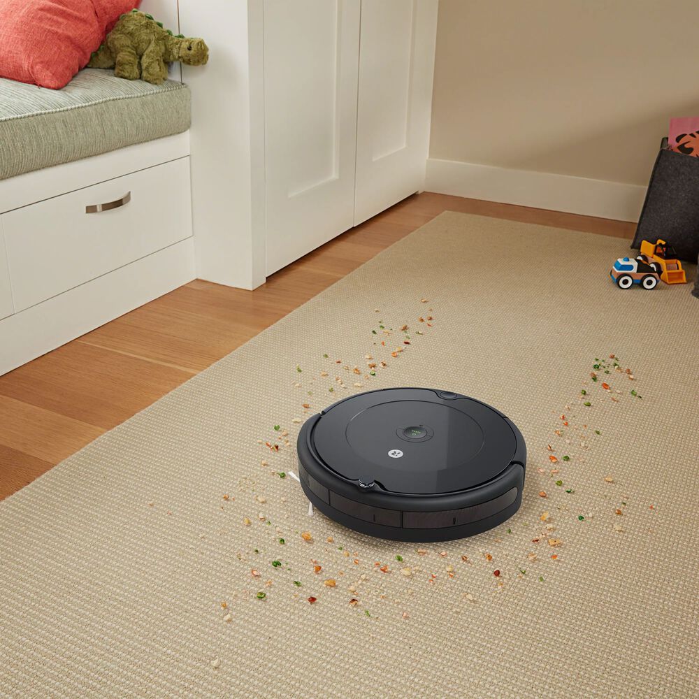Roomba 692 vacuuming a path through large particles.